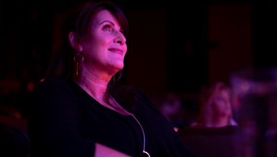 A woman looking up at the Alhambra Theatre stage