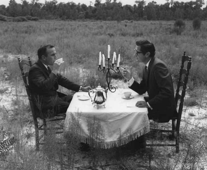 A historical photo, used on the About page that shows Ted Johnson and George Ballis having a conversation on the land that would later become home to the Alhambra Theatre.